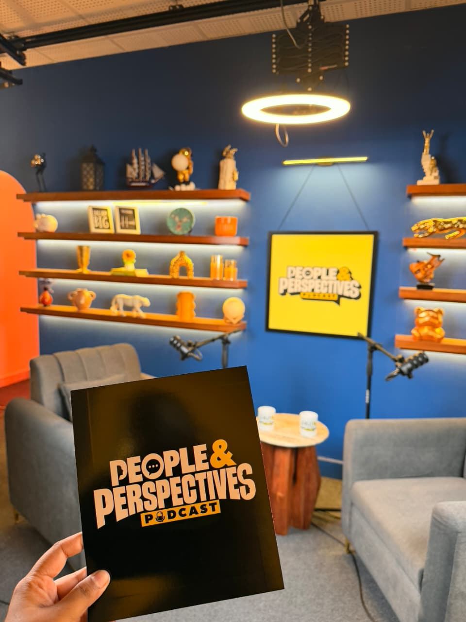 Studio set with the People & Perspectives yellow logo frame